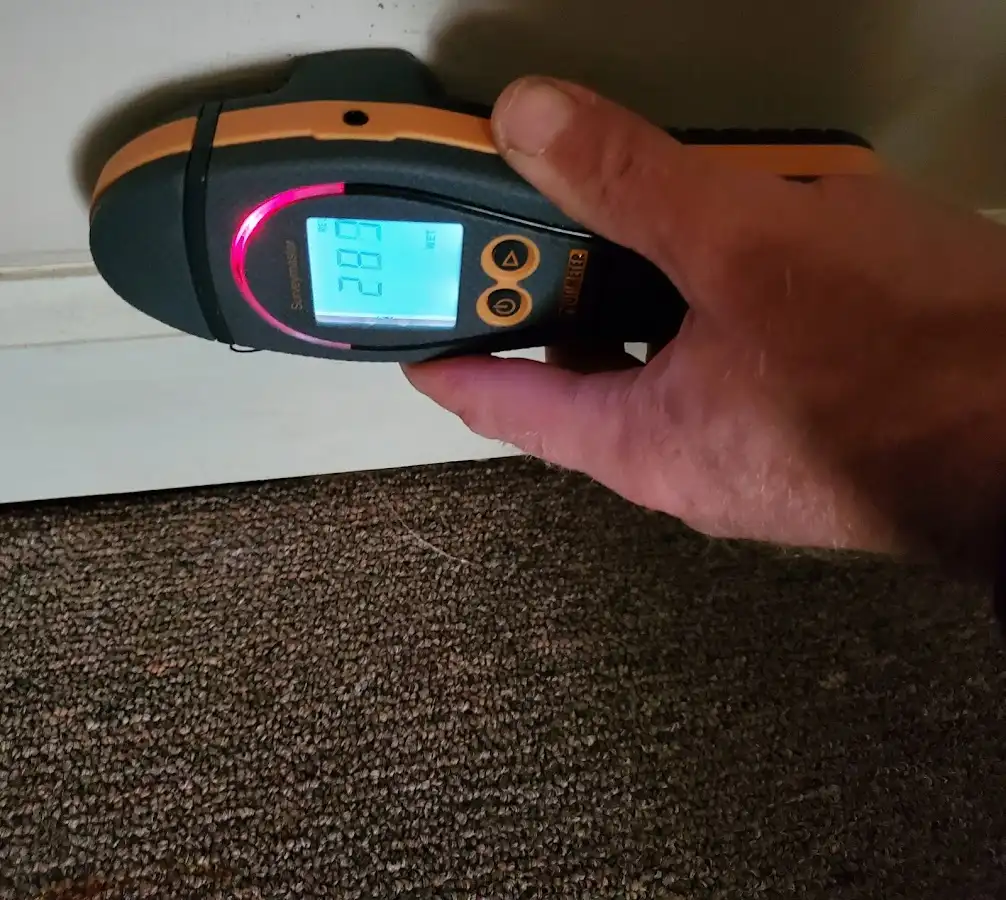 Moisture detection at baseboard during Storm Damage Restoration in Indianola